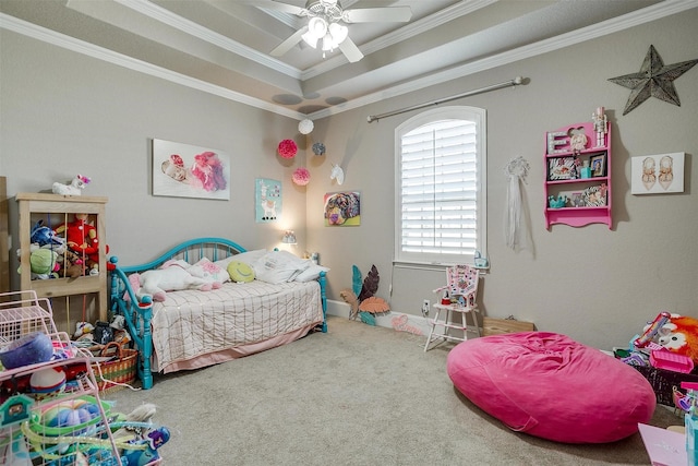 carpeted bedroom featuring ornamental molding, a raised ceiling, and a ceiling fan