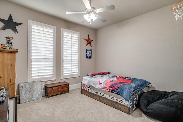 bedroom featuring light carpet and ceiling fan