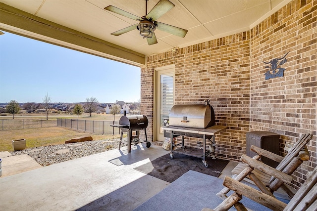 view of patio / terrace featuring fence, a ceiling fan, and area for grilling