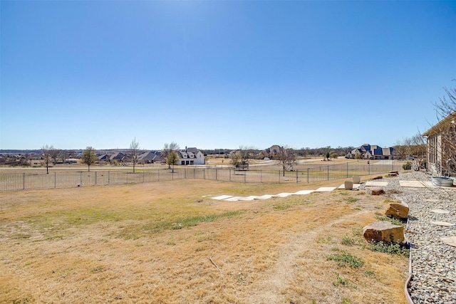 view of yard with a fenced backyard and a rural view