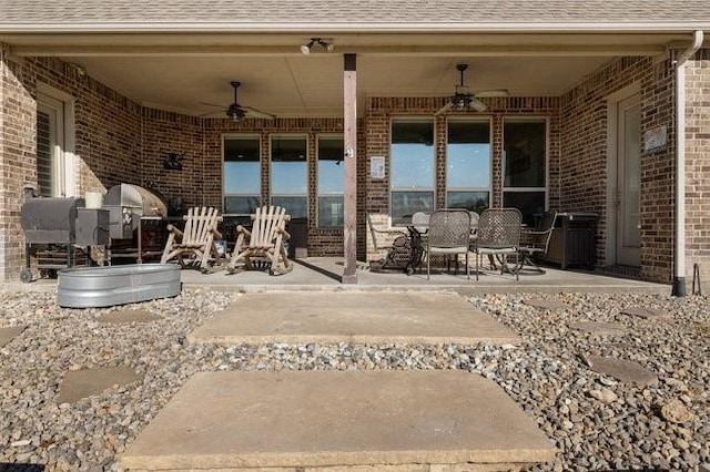 view of patio with ceiling fan and a grill