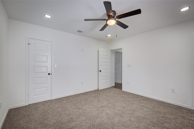 carpeted empty room featuring ceiling fan