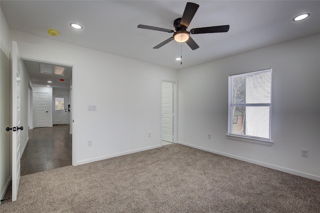 carpeted spare room with ceiling fan