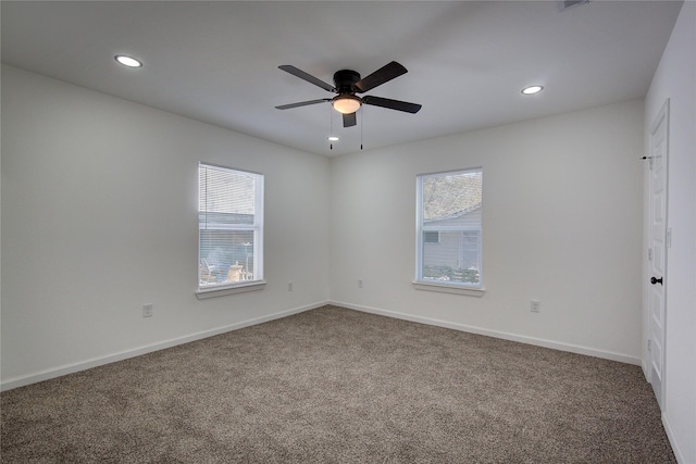 spare room with carpet flooring, ceiling fan, and a healthy amount of sunlight