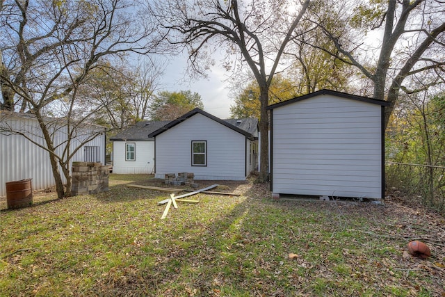 back of property featuring a lawn