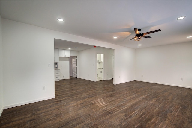 unfurnished living room featuring ceiling fan and dark hardwood / wood-style flooring