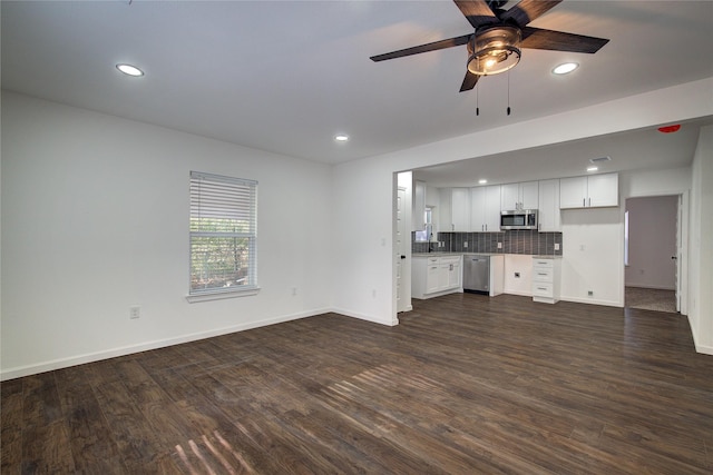 unfurnished living room featuring ceiling fan and dark wood-type flooring