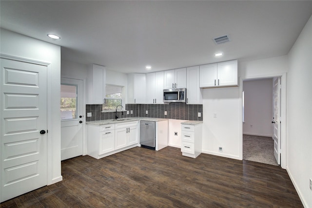 kitchen featuring dark hardwood / wood-style flooring, white cabinets, stainless steel appliances, and sink