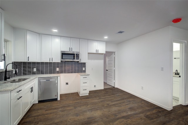 kitchen with white cabinets, dark wood-type flooring, and appliances with stainless steel finishes