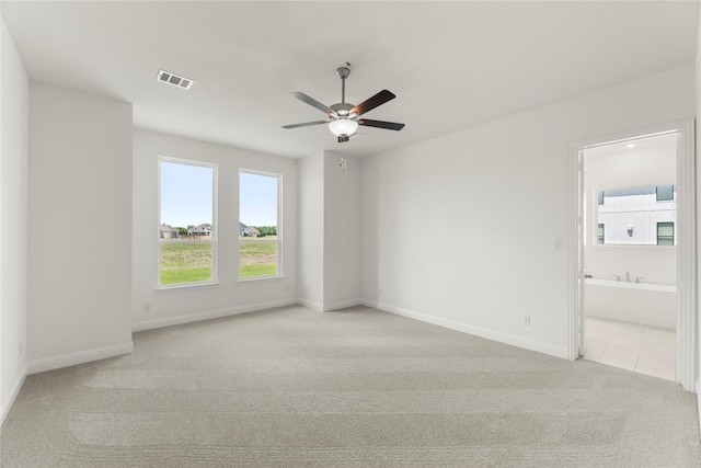 5009 Tamarack Ln, Royse City, TX 75189 - spare room featuring light carpet, ceiling fan, and baseboards