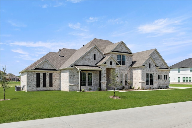 5009 Tamarack Ln, Royse City, TX 75189 - french provincial home with a front lawn, central air condition unit, brick siding, and roof with shingles