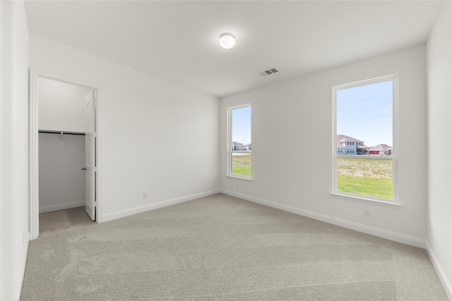 5009 Tamarack Ln, Royse City, TX 75189 - unfurnished bedroom with light colored carpet, baseboards, and a spacious closet