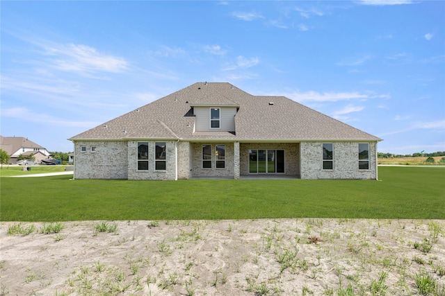 5009 Tamarack Ln, Royse City, TX 75189 - rear view of house featuring a yard, a shingled roof, and brick siding