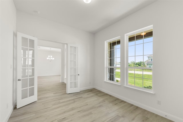5009 Tamarack Ln, Royse City, TX 75189 - spare room with french doors, wood finished floors, baseboards, a chandelier, and a smoke detector