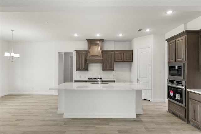 5009 Tamarack Ln, Royse City, TX 75189 - kitchen featuring stainless steel oven, custom exhaust hood, a sink, a chandelier, and baseboards