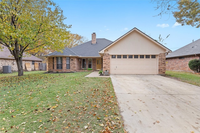 single story home with a front lawn, a garage, and central AC