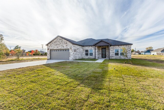 view of front of home with a front lawn and a garage