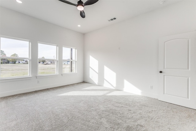 spare room featuring light carpet and ceiling fan