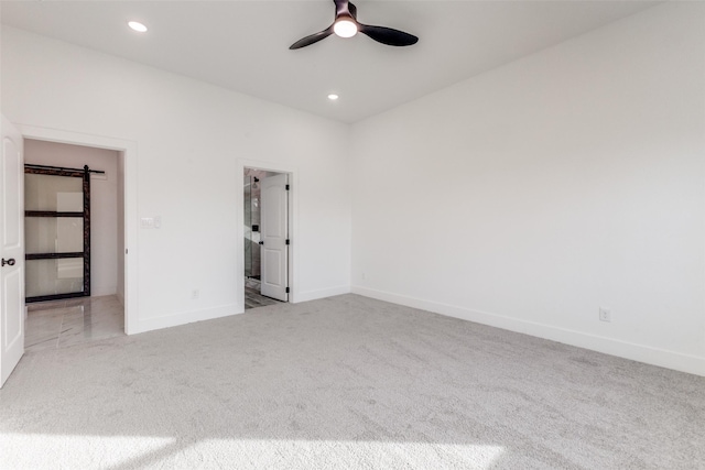 empty room with light colored carpet and ceiling fan