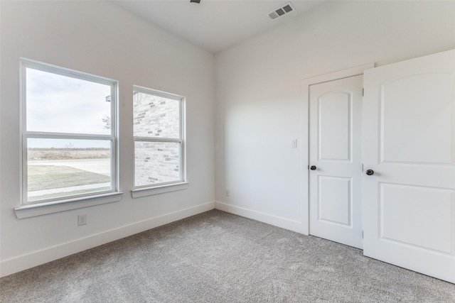 spare room with light carpet