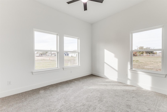 unfurnished room with carpet flooring, ceiling fan, and a healthy amount of sunlight