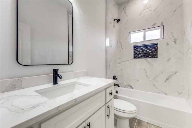 full bathroom with tiled shower / bath, vanity, and toilet