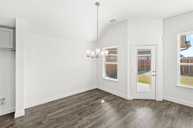 unfurnished dining area featuring dark wood-type flooring, lofted ceiling, and an inviting chandelier