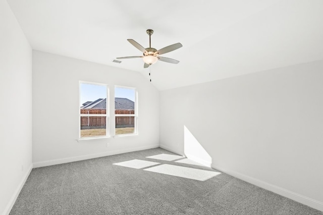 empty room with light carpet, ceiling fan, and lofted ceiling