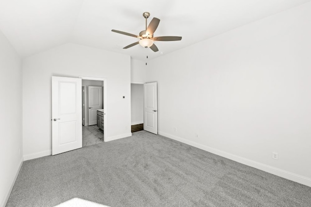 unfurnished bedroom with light carpet, ceiling fan, ensuite bathroom, and lofted ceiling