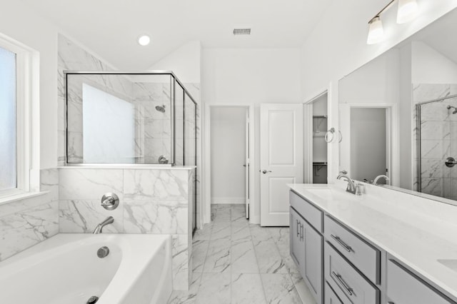 bathroom featuring plus walk in shower and vanity