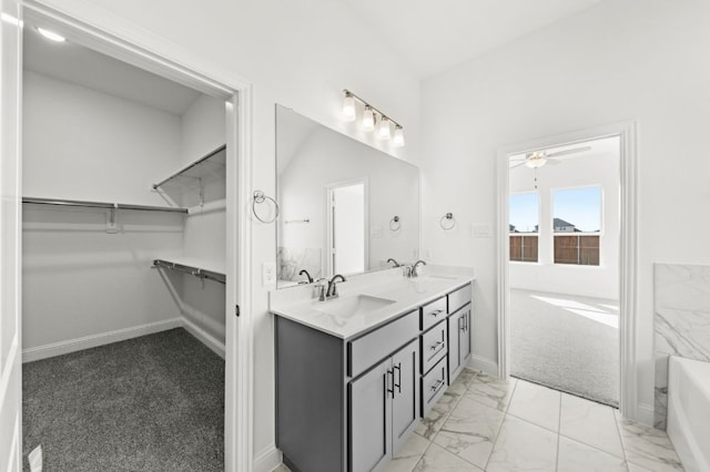 bathroom featuring ceiling fan and vanity