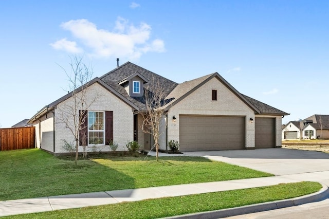 view of front of home featuring a front lawn and a garage