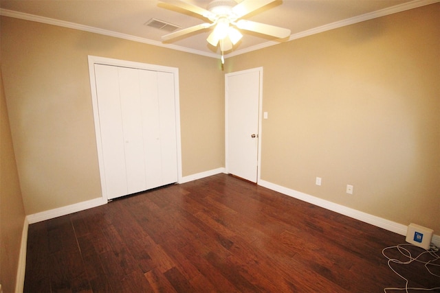 unfurnished bedroom with ceiling fan, crown molding, and dark wood-type flooring