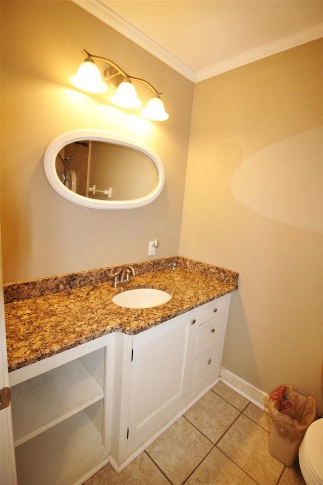 bathroom with tile patterned floors, toilet, vanity, and ornamental molding