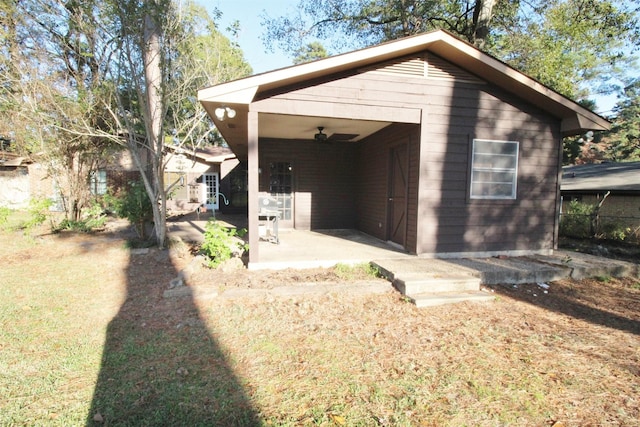 exterior space with ceiling fan