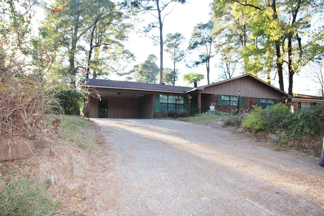 ranch-style house featuring a carport