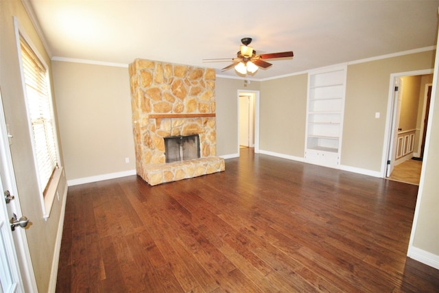 unfurnished living room with a fireplace, ornamental molding, and dark wood-type flooring