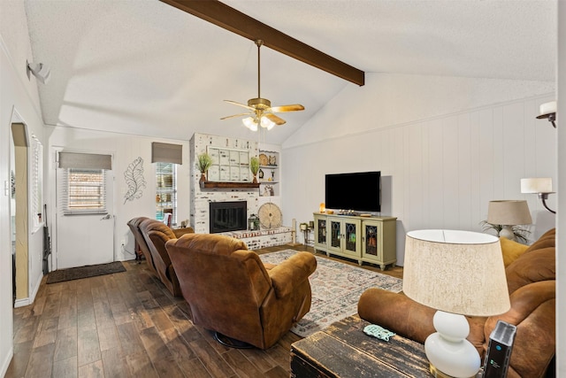 living room featuring ceiling fan, a brick fireplace, vaulted ceiling with beams, dark hardwood / wood-style floors, and wood walls