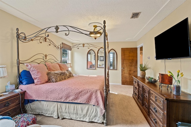 bedroom with carpet and a textured ceiling