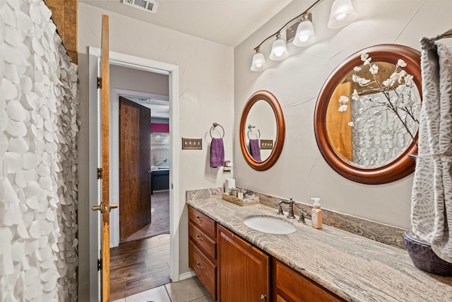 bathroom featuring a shower with curtain, vanity, and wood-type flooring