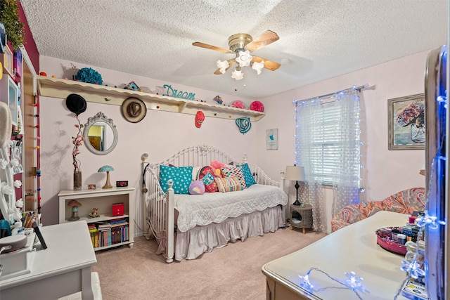 carpeted bedroom featuring ceiling fan and a textured ceiling