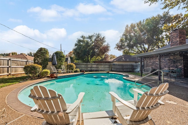 view of pool with a diving board