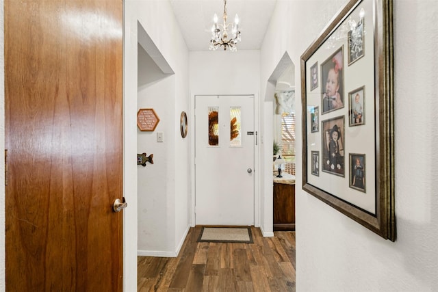 interior space with dark hardwood / wood-style flooring and a notable chandelier