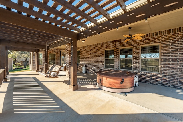 view of patio / terrace featuring a pergola, ceiling fan, and a hot tub