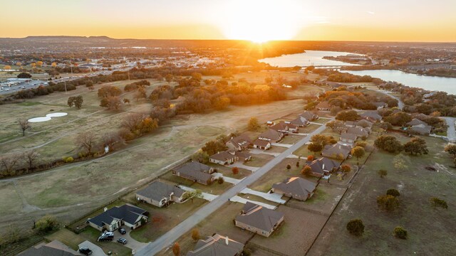 back house at dusk with a yard