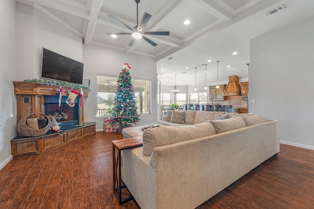 living room featuring beam ceiling, dark hardwood / wood-style floors, ceiling fan, and coffered ceiling