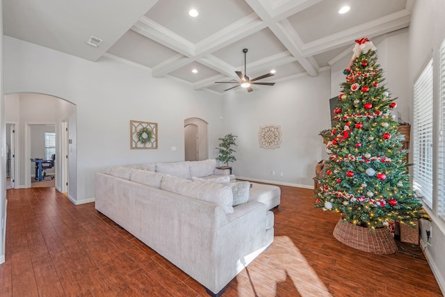 living room featuring beam ceiling, dark hardwood / wood-style flooring, ceiling fan, and coffered ceiling