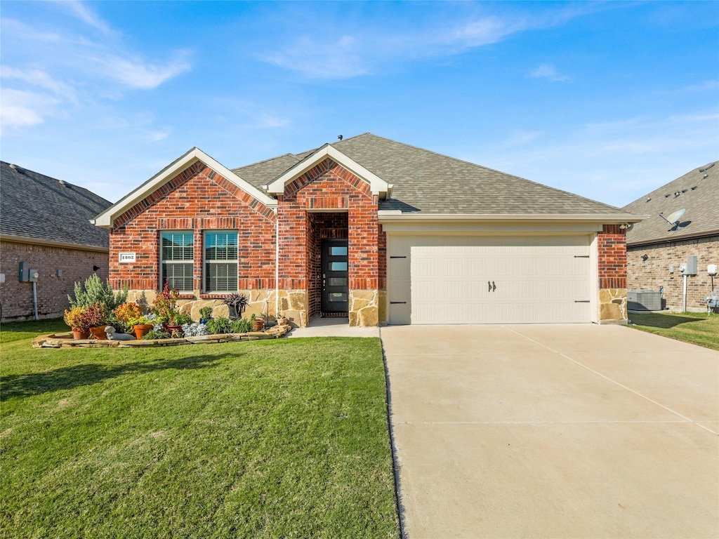 view of front of house featuring a garage, central AC unit, and a front lawn