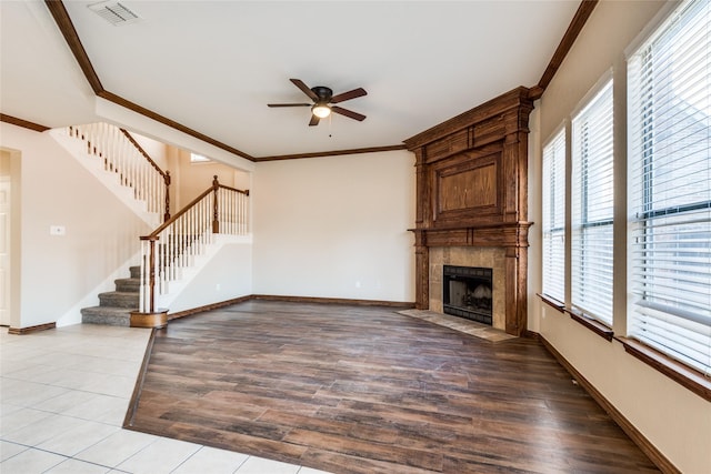 unfurnished living room featuring plenty of natural light, light hardwood / wood-style floors, a fireplace, and ceiling fan