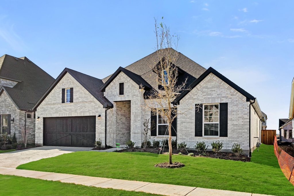 french country style house featuring a front yard